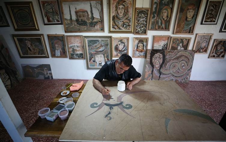 Nîgarkêşek li Çewlîgê bi kevirên rengîn tabloyên bêhempa çêdike