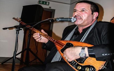 Musician Eli Singali: A Kalashnikov Over One Shoulder, a Saz on the Other