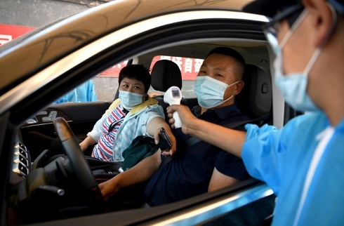 Europe reopens borders but China battles new virus outbreak