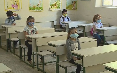 Masked first, second grade students go back to school in Kurdistan Region