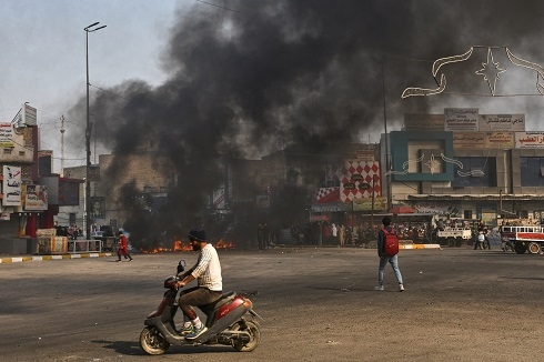 Iraqi policeman shot, dozens wounded in protests