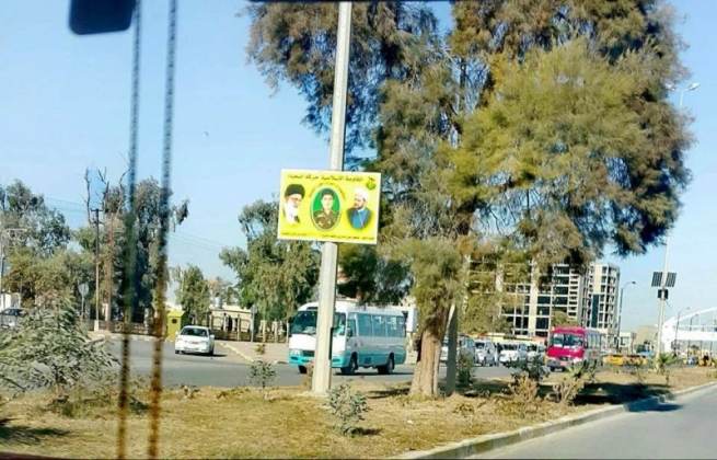  حەشدی شەعبی وێنەی خامنەیی لە شەقامێکی كەركووك هەڵدەواسن 