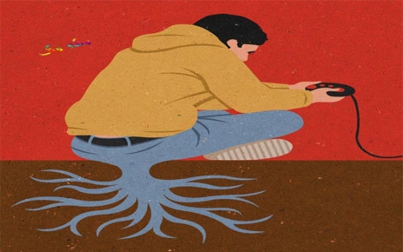 كاریكاتێرێكە باس لە گەنجی ئەم سەردەمە دەكات، كە زۆربەی كاتەكانی ژیانیان بە یارییە ئەلیكترۆنییەكان و مۆبایلەوە خەریك كردووە، كە هێندە بەدیار یارییەكانەوە دادەنیشن تا وایان لێهاتووە وەك دار رەگ